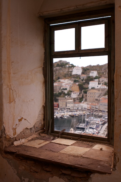 Photo of a greek harbour framed by an old window