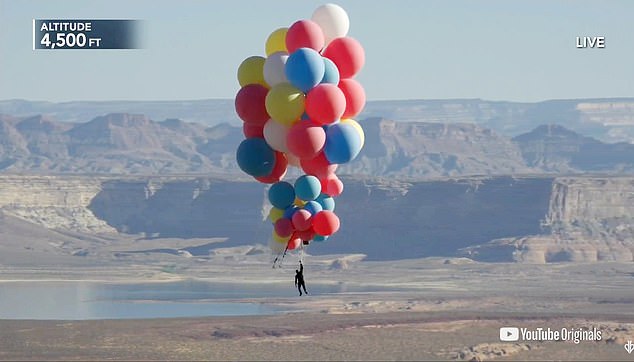 Magician David Blaine, pictured, soaring above the Arizona desert during his latest stunt