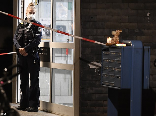 A policewoman stands in front of the apartment building in Solingen, Germany, on Thursday night