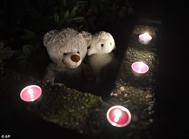 Teddy bears and candles are left out in tribute to the five children who died in what the state