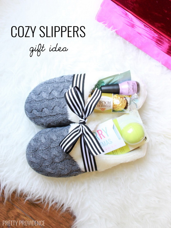 Cozy Slippers Gift Idea. A fun way to give gifts with this cozy slipper with little trinkets! It is perfect for a family member and stuffed a few small gifts and treats into them and wrapped it all up with a bow. 