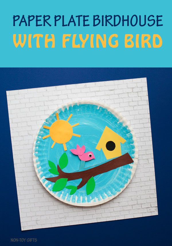 Paper plate birdhouse craft for kids. It has a flying bird glued on a stick that kids can move along the tree branch. Fun spring or summer craft. 