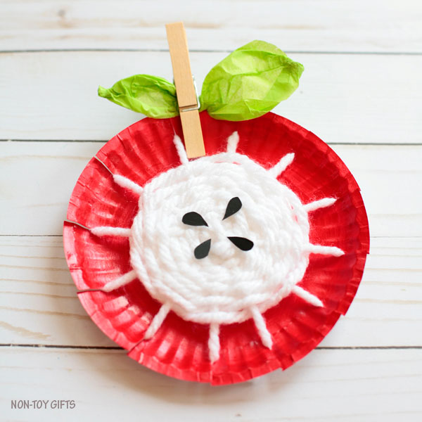 Paper plate yarn weaving craft for kids to try this fall.