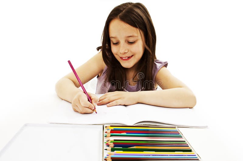 Absorbed little girl drawing with colorful pencils. On white background royalty free stock image