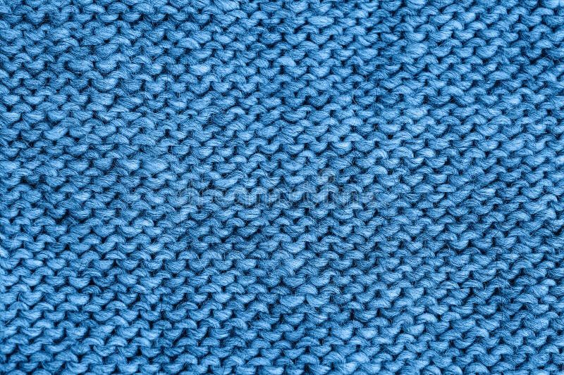 Blue knitted texture. Handmade Knitwear. Color of the year 2020 classic blue toned. Background. Blue knitted texture. Handmade Knitwear, reverse stitch. Color of stock images