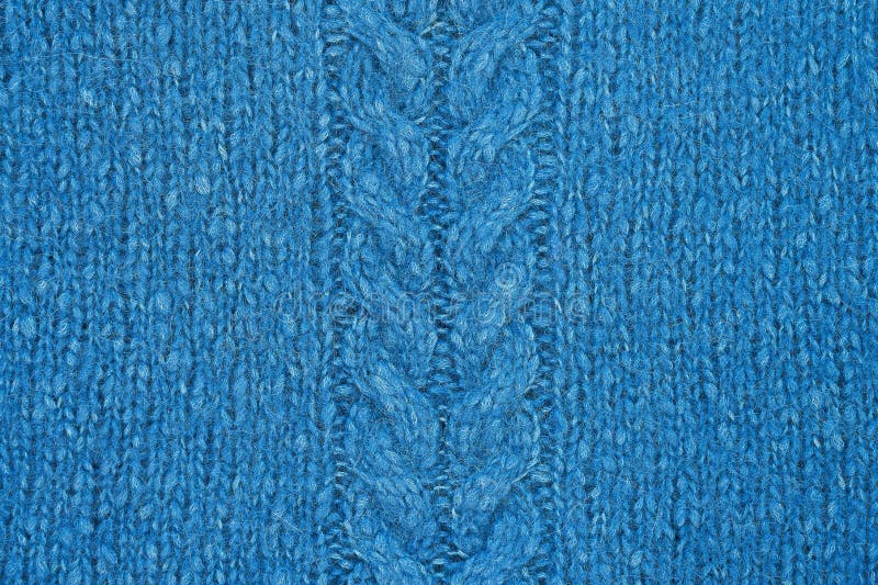Blue knitted texture with a relief pattern in the middle. Handmade Knitwear. Background, abstract royalty free stock photos