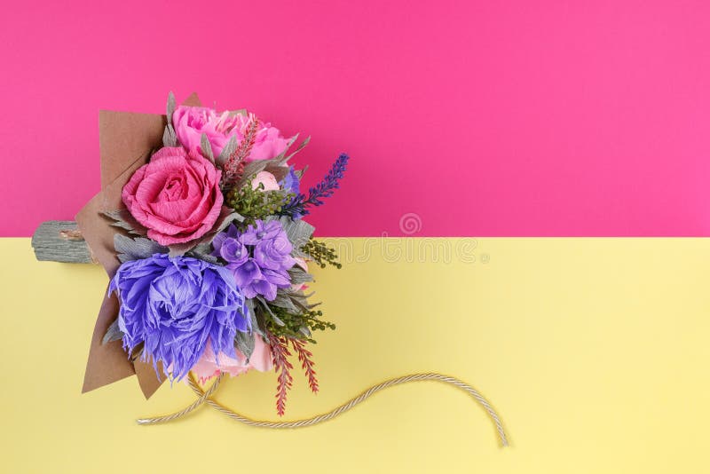 A bouquet of colorful paper flowers on magenta and yellow backgrounds as a backdrop for a postcard, invitation letter and etc.  royalty free stock photos