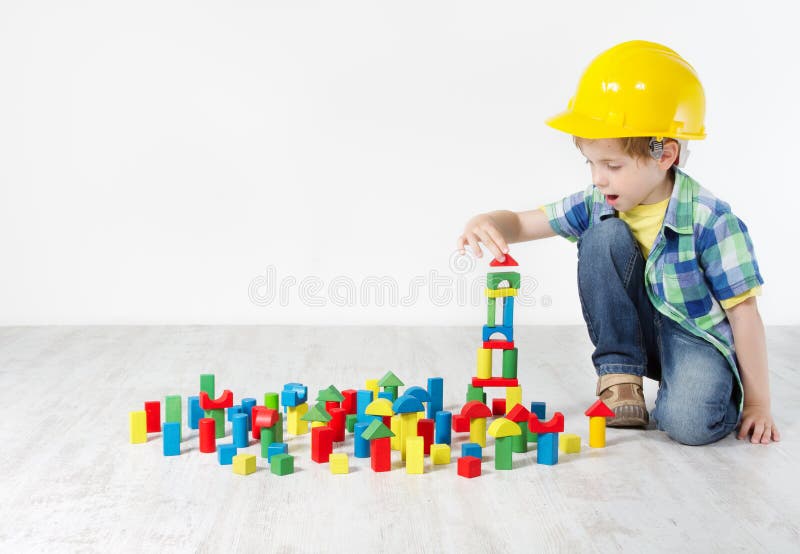 Kids Play Room, Child in Hard Hat Playing Building Blocks Toys stock photography
