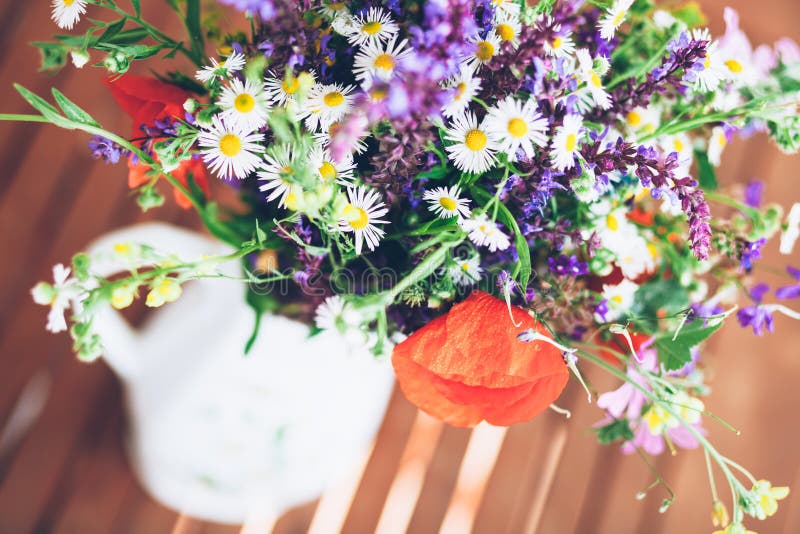 Bunch of wild herbs and flowers in a vase stock photos