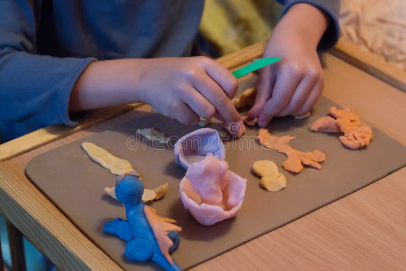 Child hands playing with colorful baby play dough, plasticine stock images
