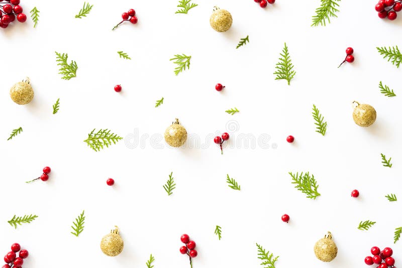 Top view of spruce branches, pine cones, red berries and golden ball on white background. royalty free stock photo