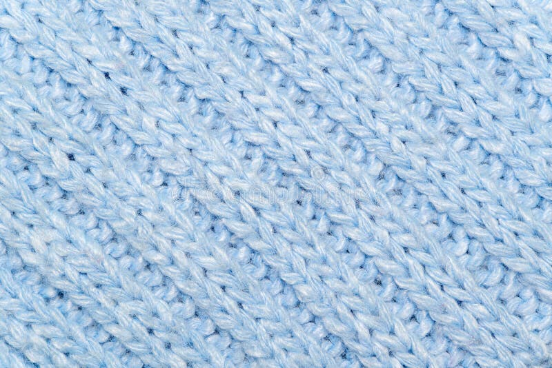 Blue knitted wool fabric background. Very warm natural knitwear handmade. Close-up to blue knitted wool fabric background. Very warm natural knitwear handmade royalty free stock image