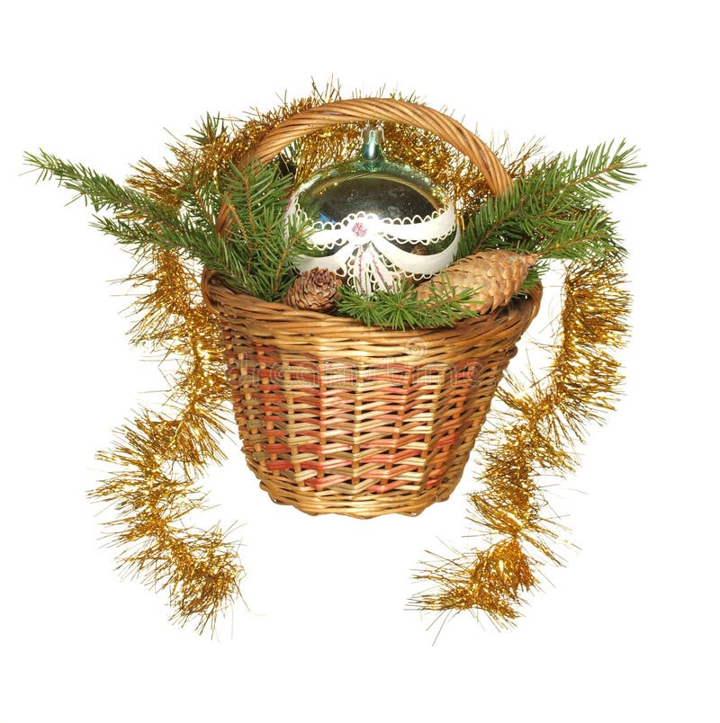Decorative basket with New Year`s toys, fir branches and cones isolated on a white background royalty free stock photo