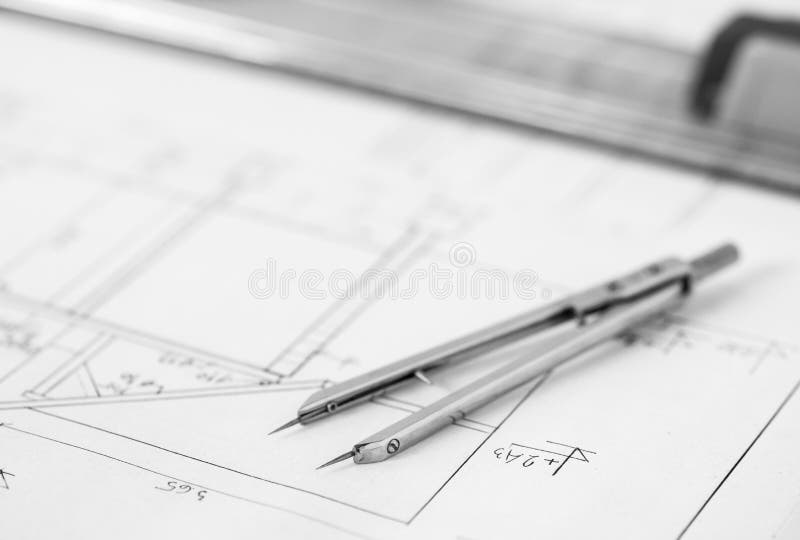 Divider on technical drawing. Vintage divider placed on a technical drawing stock image