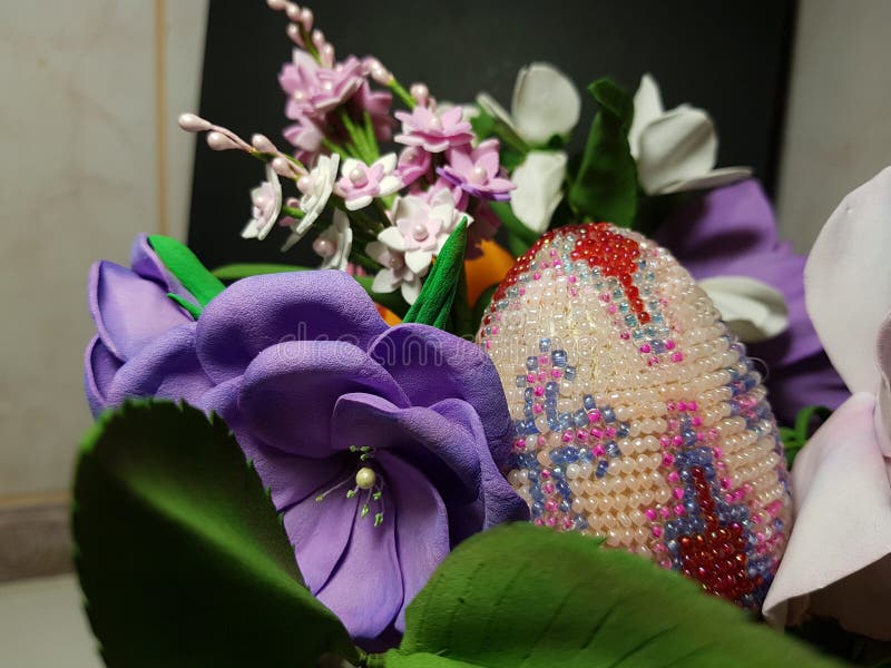 Easter decoration egg from beads in flowers from material fom colorful and bright. stock photos