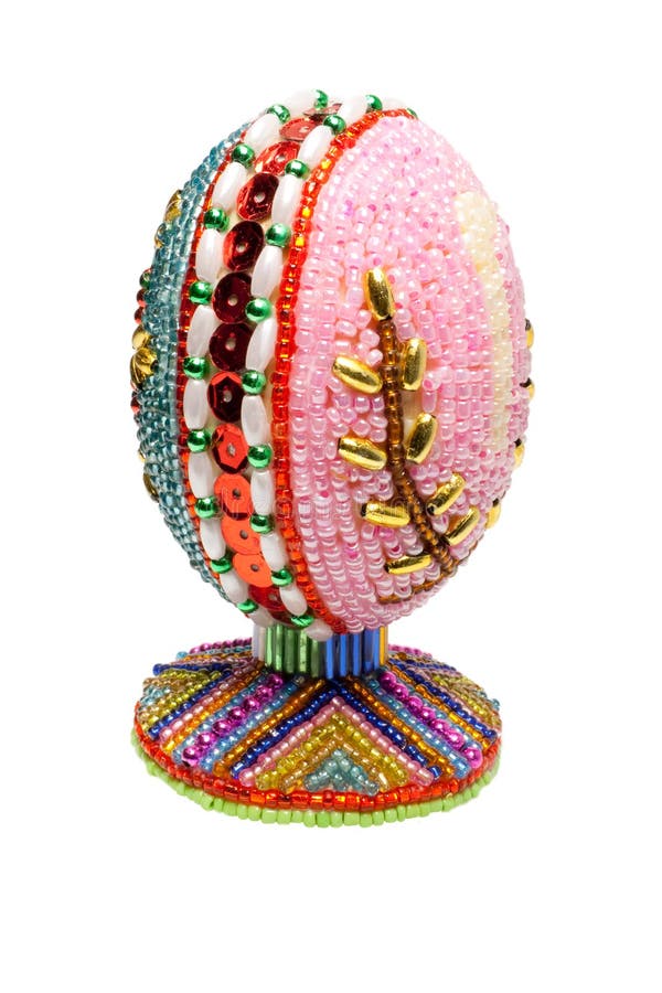 Easter egg. An easter egg is decorated a bead on a white background royalty free stock photos