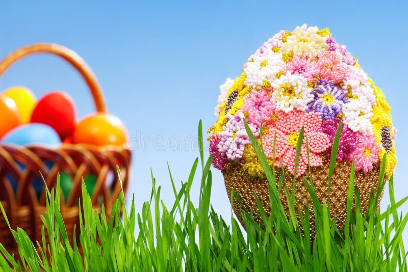 Egg with beads. Easter egg decorated with beads in green grass stock photo