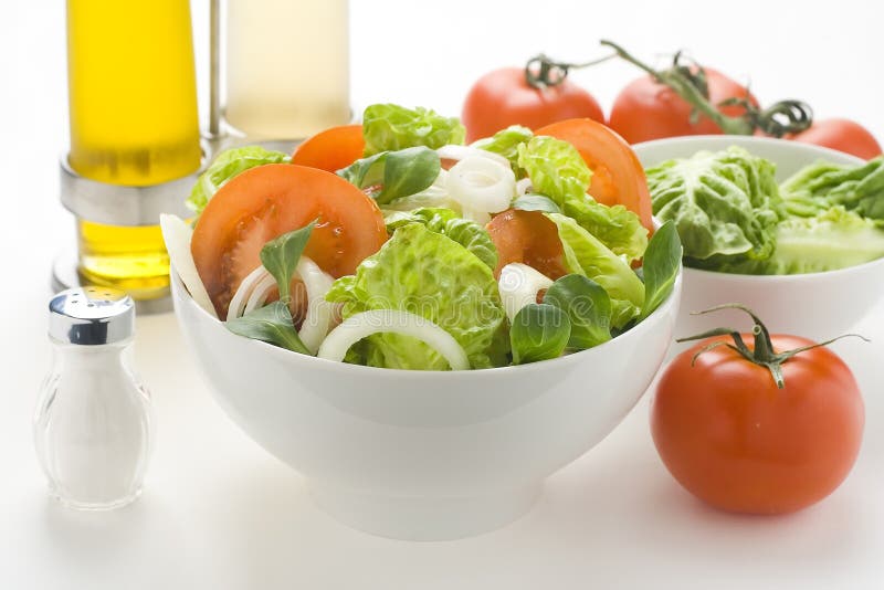 Fresh natural salad bowl tomato lettuce onion. Oil vinegar stock image