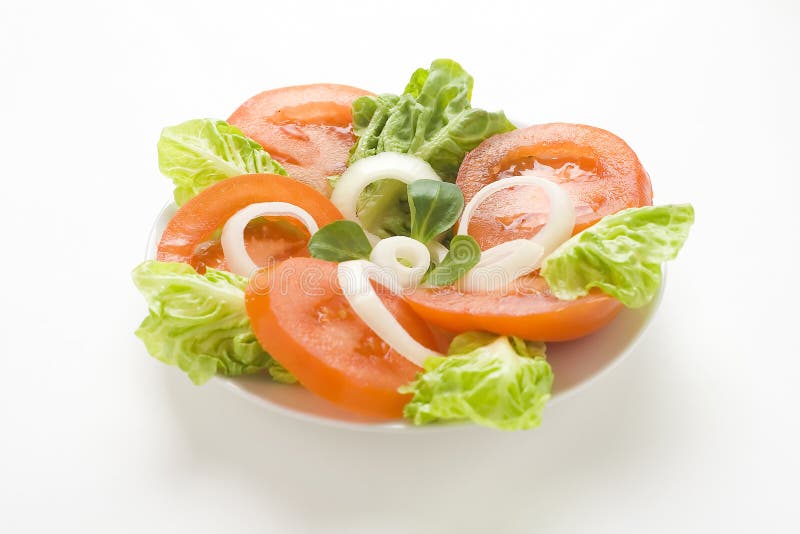 Fresh natural salad bowl tomato lettuce onion. Oil vinegar stock photo