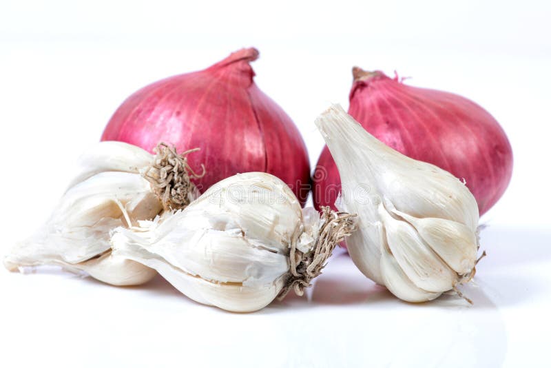 Garlic and onions. Beautiful shot of garlic and onions over white background stock image
