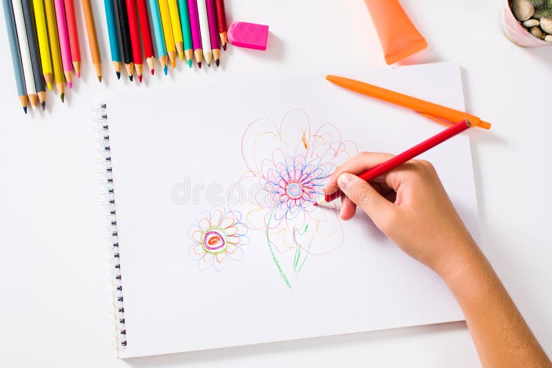 Girl drawing a colorful flower first person royalty free stock photo