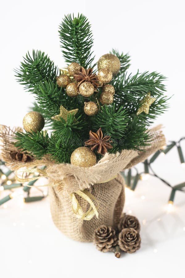 Golden decorated artificial Christmas tree isolated on white stock image