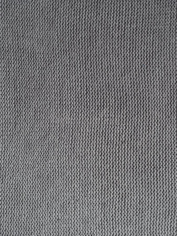 Gray knitted textured background, knit with purl loops. Hand knitting. With woolen yarn royalty free stock image