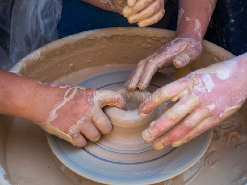 Master class on modeling of clay on a potter`s wheel In the pottery workshop for children sunny day stock images