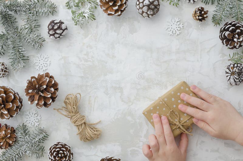 Master class to create a gift box wrapping with kraft paper and rope.Children`s creativity.Favorite hobby for children royalty free stock images