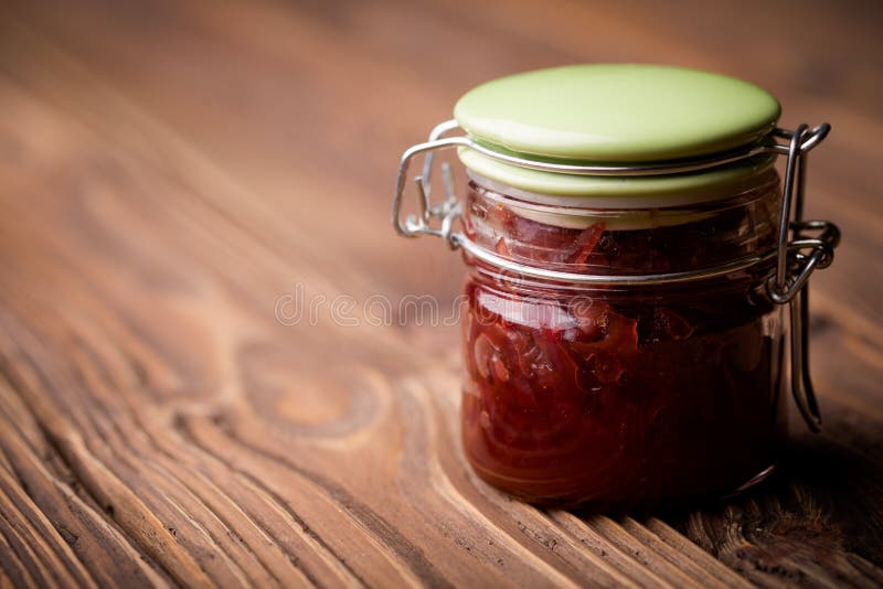 Natural diy red onion marmalade. Homemade DIY natural healthy red onion marmalade with rasberry sirup stock photo