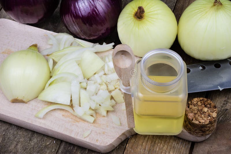 Onion and medicinal juice for a cold. Natural and alternative me. Thods of treatment. Light background stock image