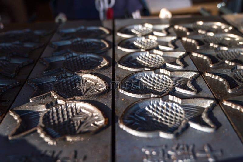 Pan pattern and stove machine for cooking Taiyaki; Japanese fish-shaped cake dessert. Pan pattern and stove machine for cooking  Taiyaki; Japanese fish-shaped royalty free stock photography