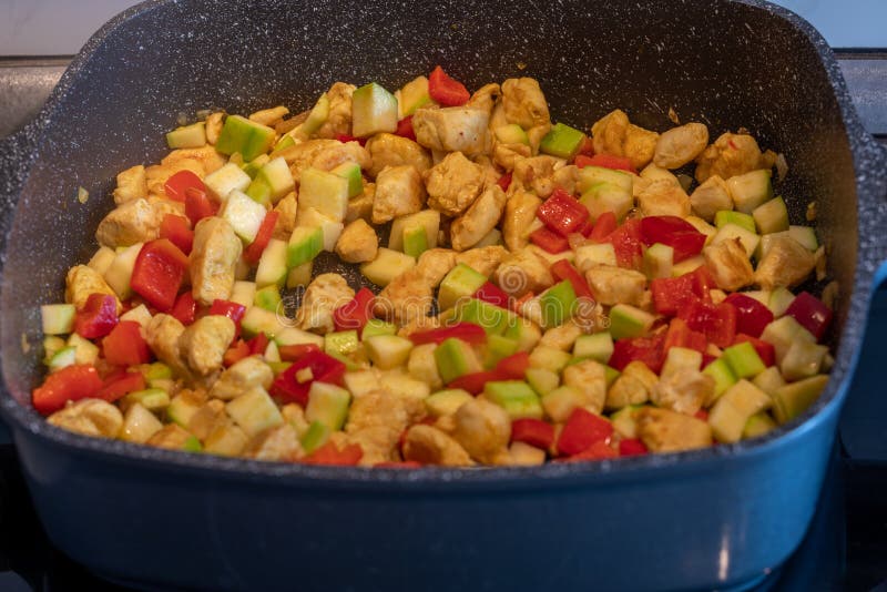 Picture of the frying colourful meal in the pan close up. Background of the colourful frying meal pattern close up.  stock photo