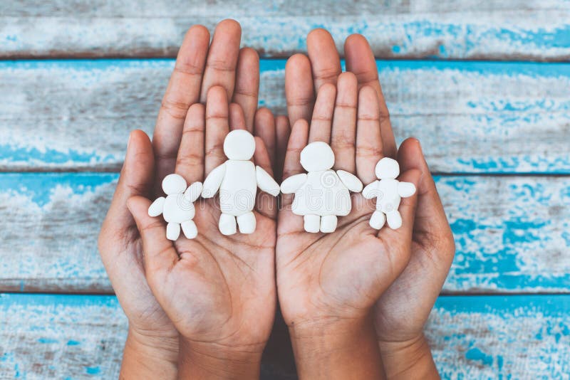 Plasticine clay happy family on child and parent hands.Happy family and love concept. Plasticine clay happy family on child and parent hands. Happy family and stock photography