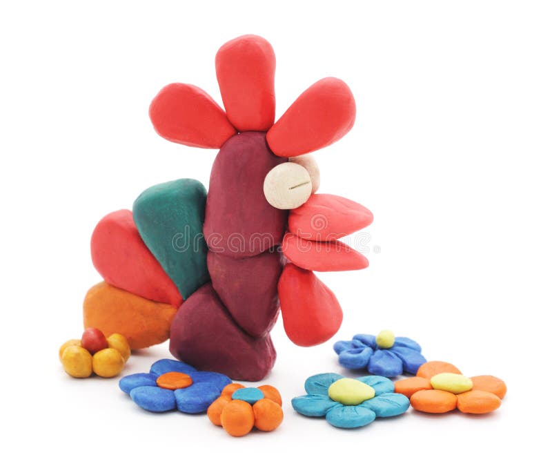 Plasticine rooster and flowers. Plasticine rooster and flowers on a white background stock image