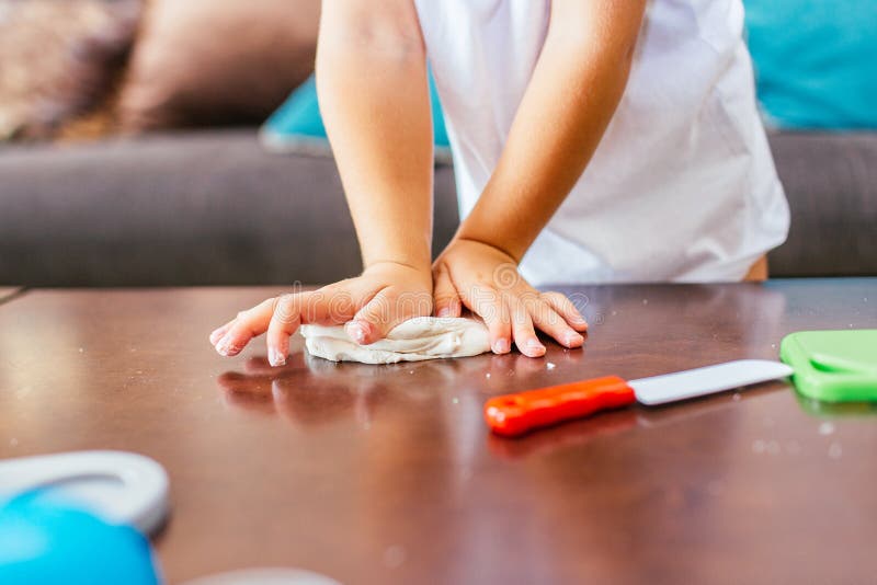 The process of play dough modeling, the child`s hands sculpt figures. Play dough in preschool or nursery for education concept stock photos