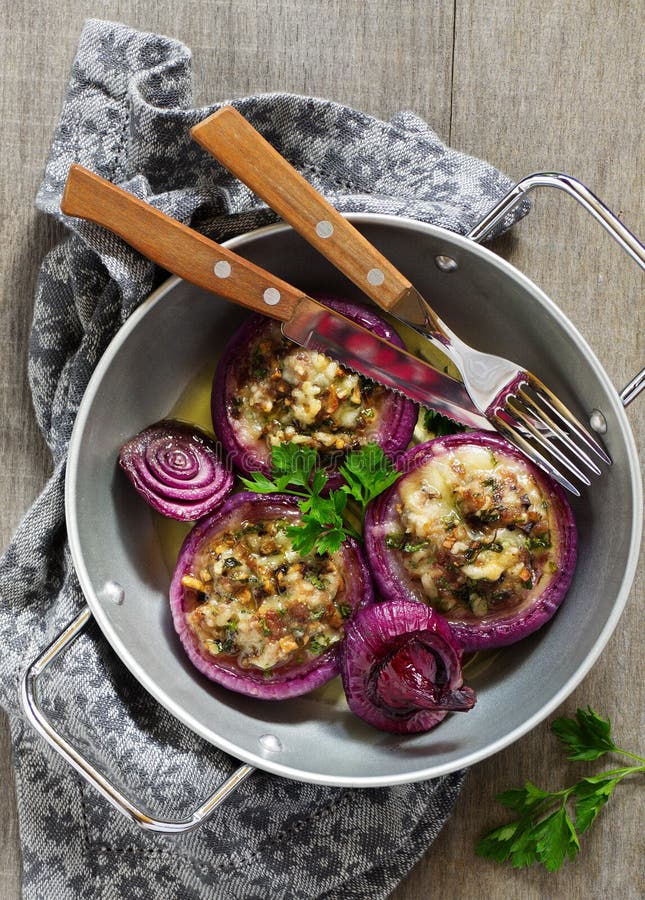 Red onions stuffed with goat cheese. And bacon royalty free stock photography