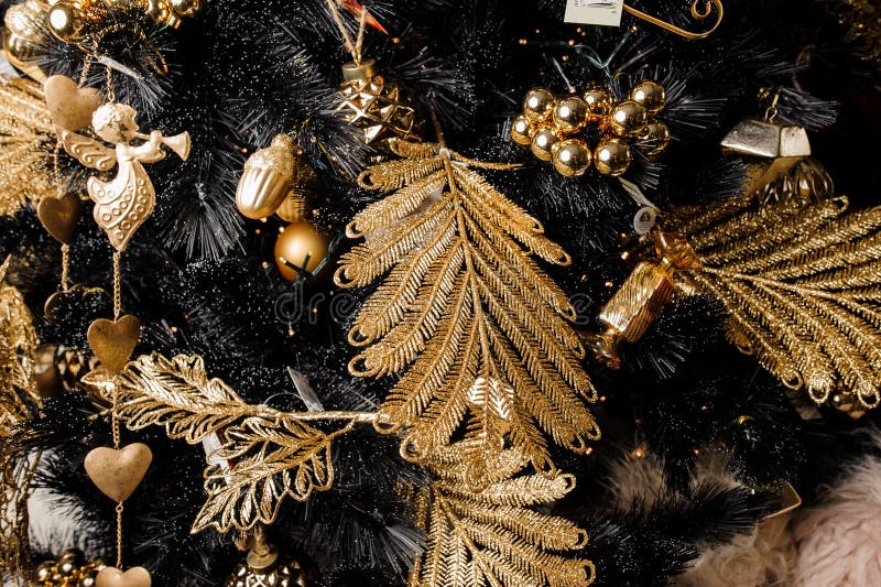 Christmas decorative garland in golden tones and in a form of leafs, angels and cones stock photography
