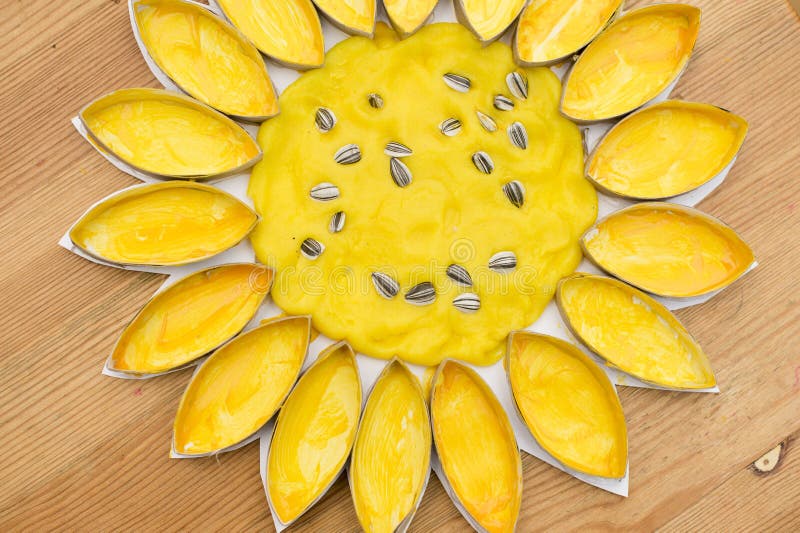 Sunflower DIY crafts. DIY home made Sunflower blossom with natural sunflower seeds. an eco-friendly game made of flour and toilet paper cores. reuse that what stock image