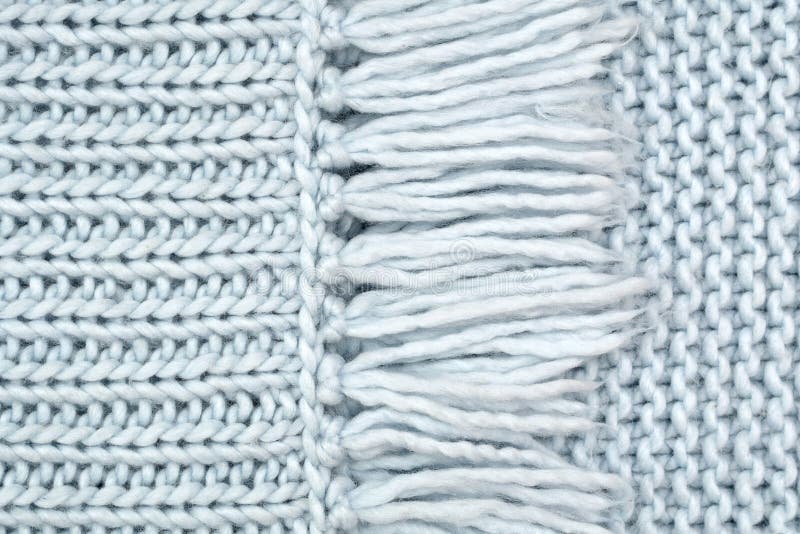 The texture of knitted wool fabric from the front and purl loops with fringe.  stock images
