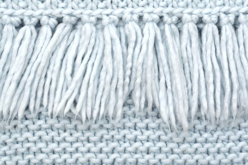 The texture of knitted wool fabric of purl loops with fringe.  stock images