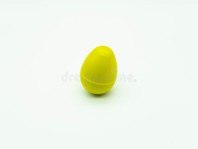 Top view of yellow egg shaker on white background. Percussion instrument concept. Top view of yellow egg shaker on a white background. Percussion instrument stock photo