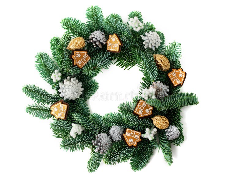A traditional green christmas wreath isolated with houses and silver cones as a decoration. royalty free stock images