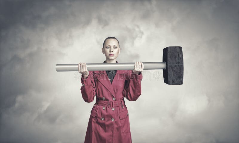 Woman with hammer stock photography