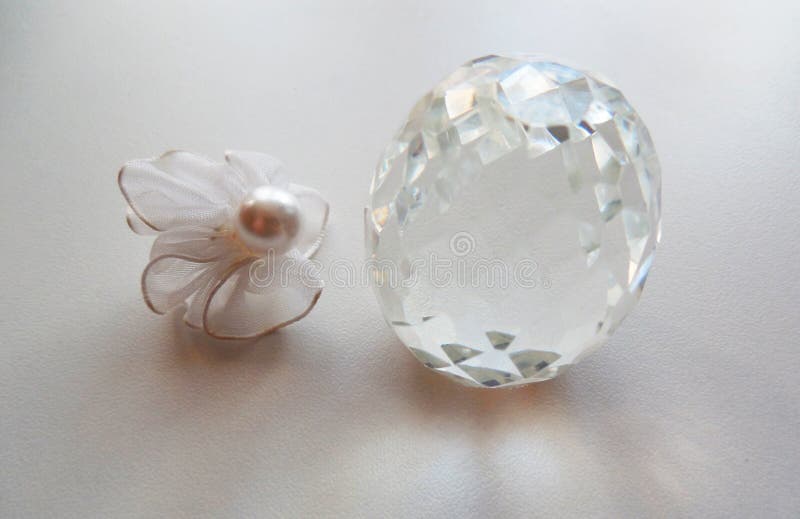 Сrystal egg and pearl bead. Сrystal egg near pearl bead decoration on white background in table royalty free stock image