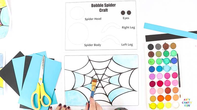 Paint the printable Halloween spider web. 