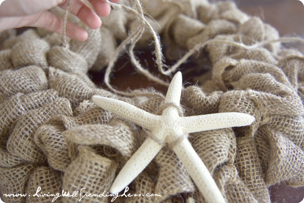 Secure the starfish ornament to the front of the wreath using twine. 